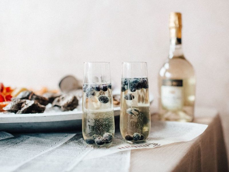 Cocktails With Liquor Bottle And Plate of Oysters