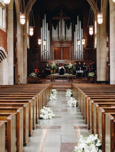 A look down the aisle toward the altar of the Scarritt Bennett Center, decorated with white floral arrangements