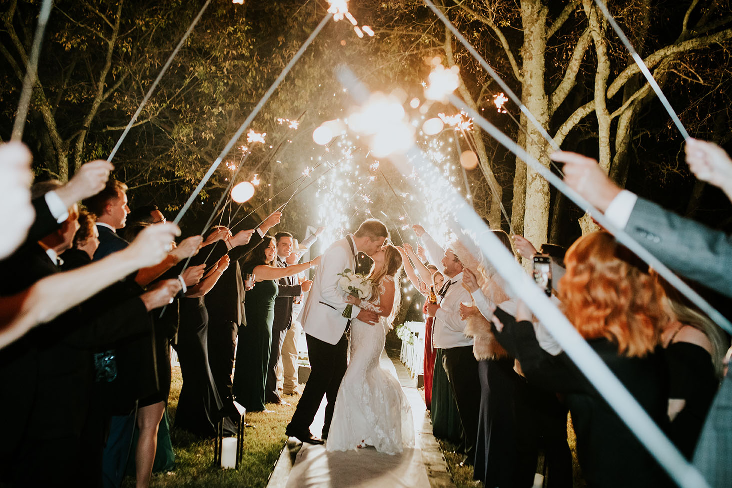 Jessie and Tim Kissing During Sparkler Wedding Exit