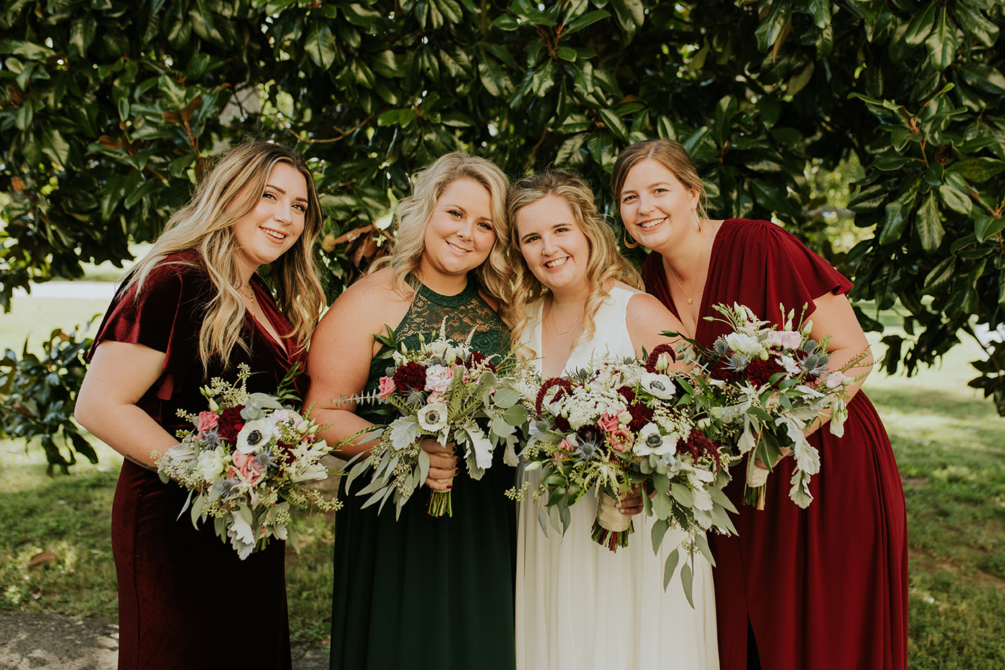 Bride and Bridesmaids Posing With Bouquets