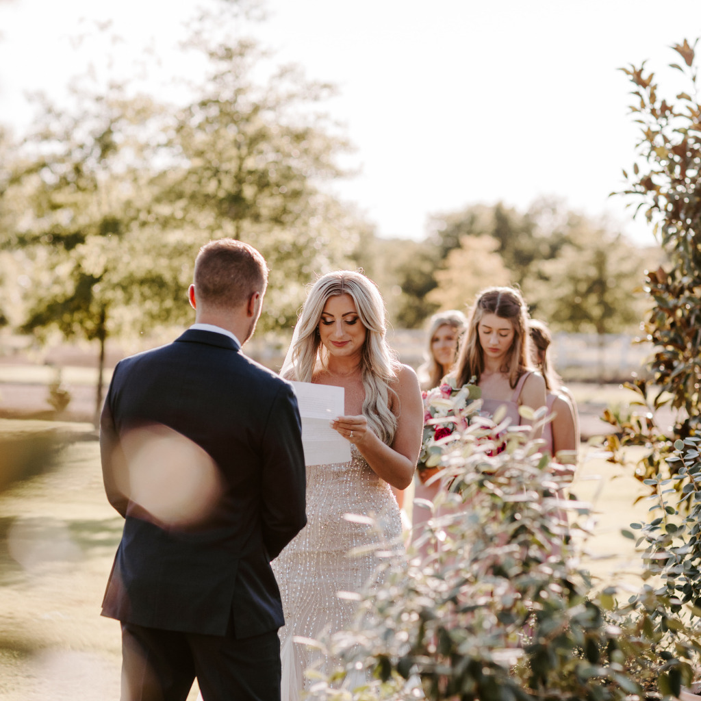 Bride Reading Wedding Vows To Groom During Reception