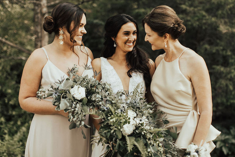 A mother smiles lovingly at her daughter on her wedding day