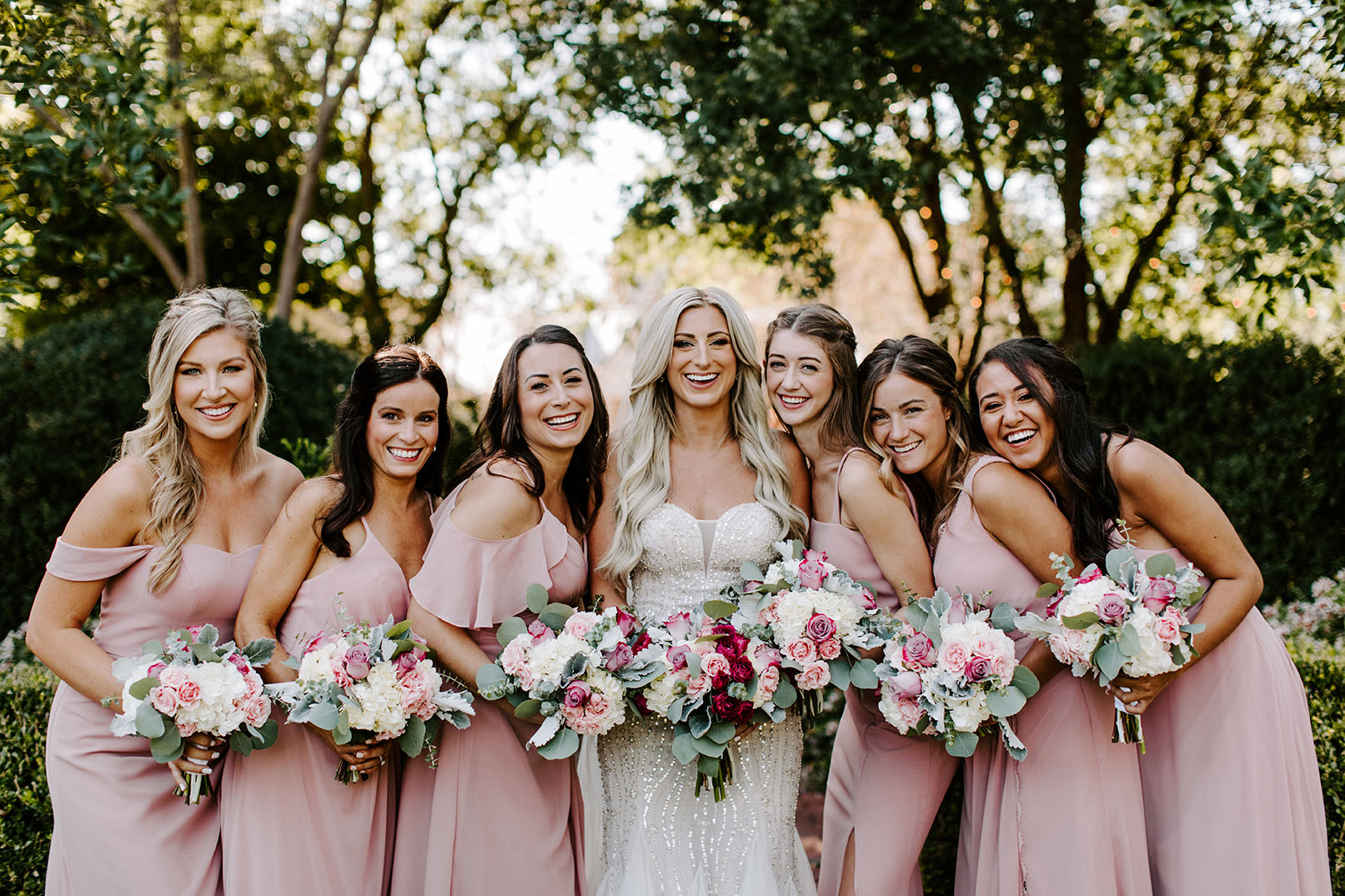 Bride with Bridesmaids Wearing Pink and Holding Bouquets