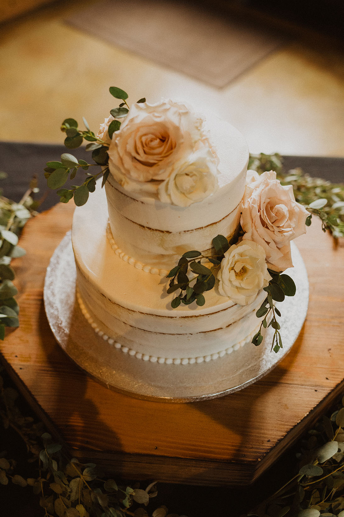 White Two Tier Wedding Cake Topped with Flowers