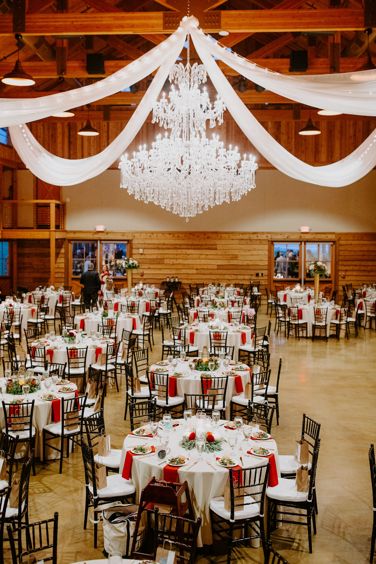 Chandelier With White Drapery In The Wedding Reception Tables