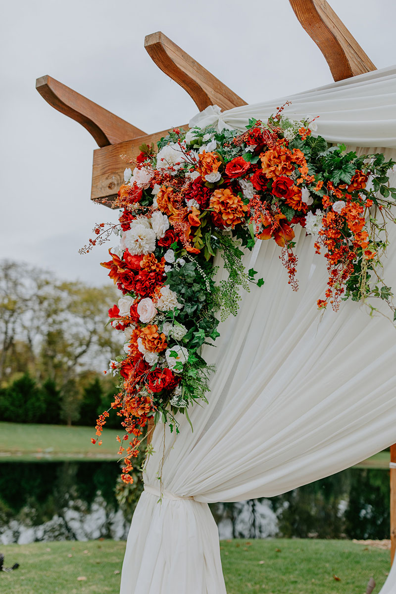 Wooden Pergola With White Drapery And Flowers