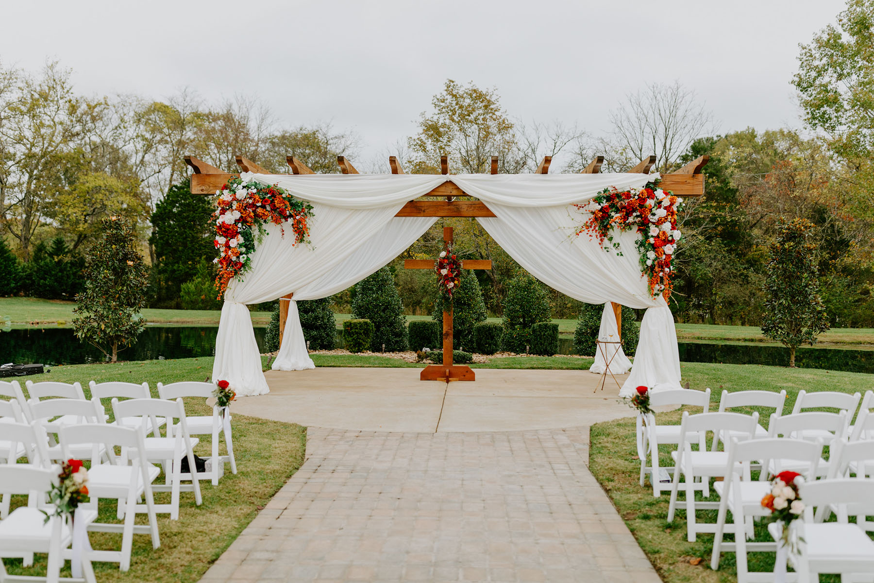 Wooden Pergola With White Drapery And Flowers