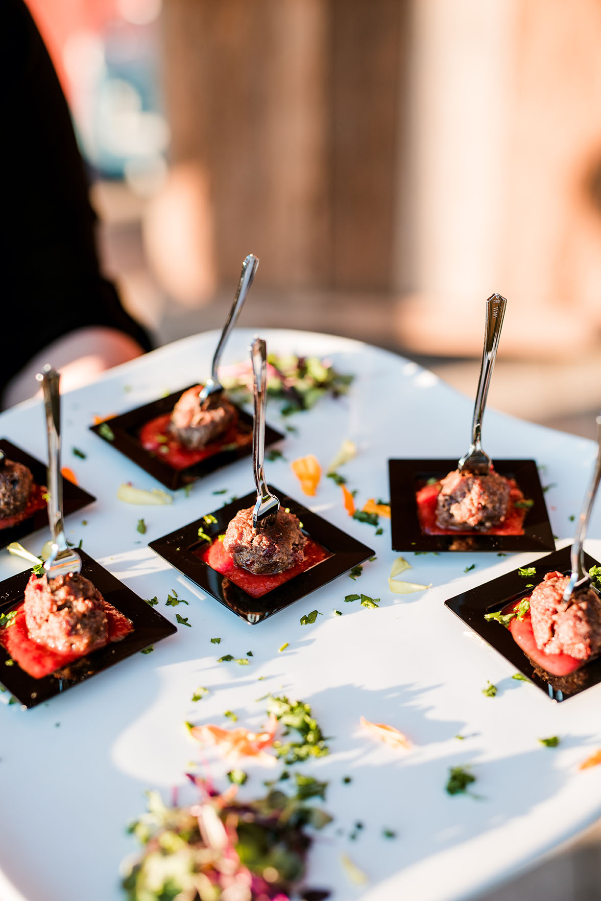 Server Holding Cranberry Meatballs For Cocktail Hour