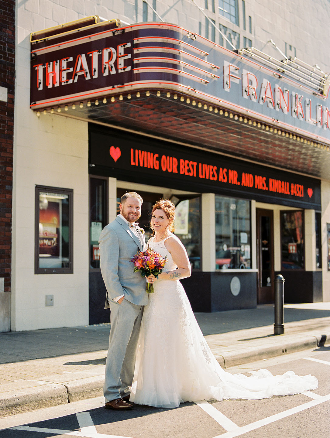 Bride and Groom Posing in Front of Franklin Theatre