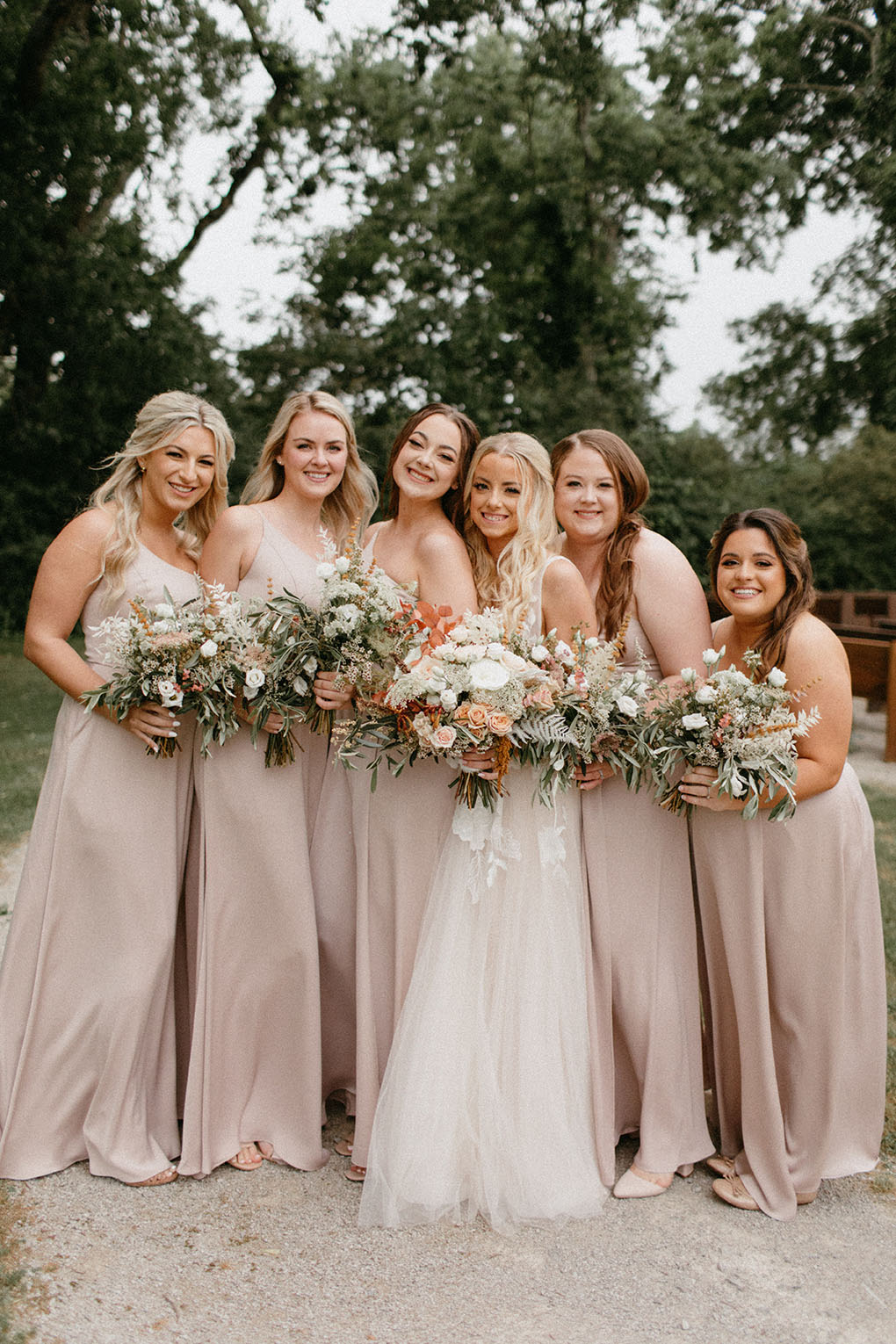 Bride Posing with Bridesmaids Wearing Pale Pink