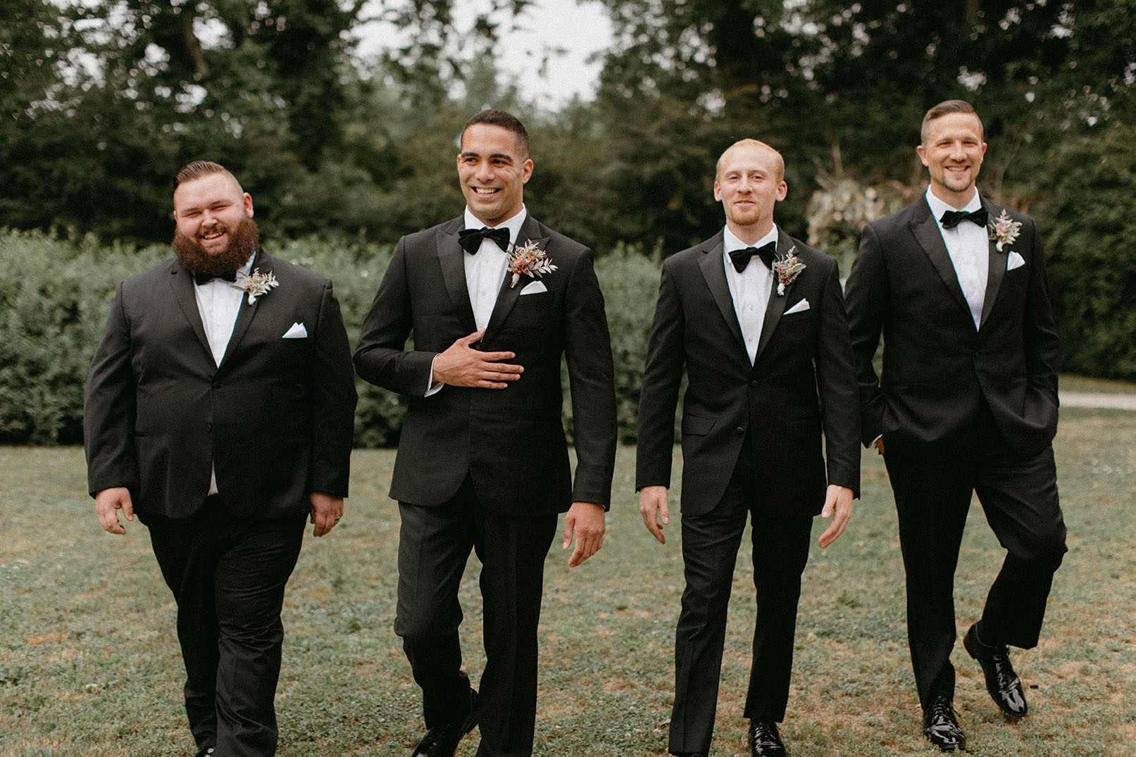 Groom Walking with Groomsmen in Black Tuxes