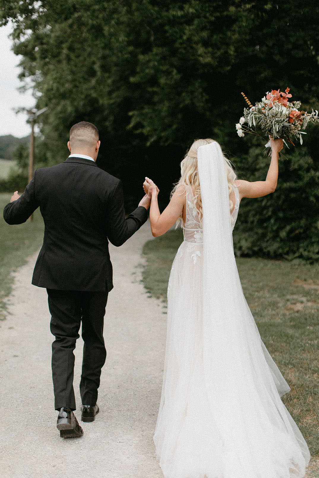 Bride and Groom Walking Down Walkway at End of Ceremony