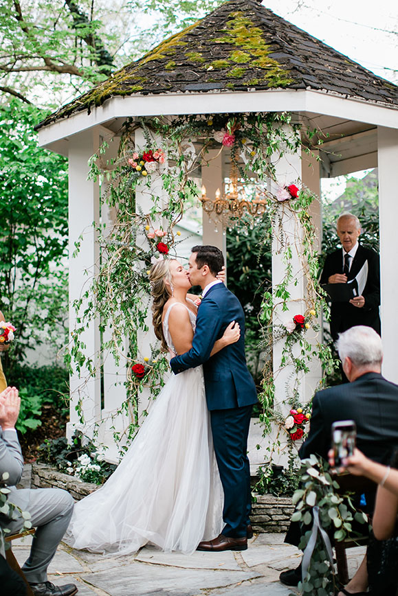 Sydney and Patrick Kissing at Wedding Ceremony Altar