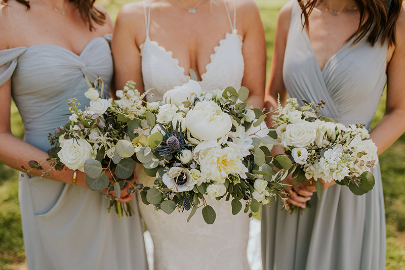 Close up up bride and bridesmaids with bouquets