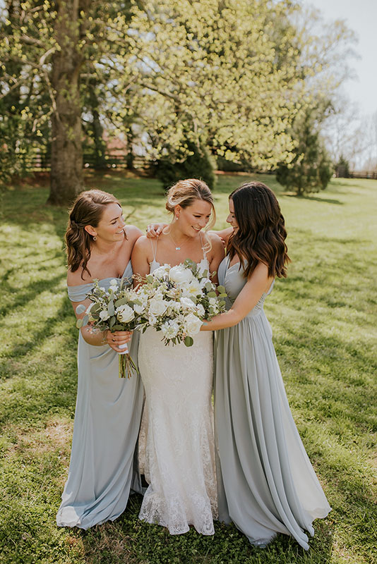 Bride and bridesmaids outdoors with bouquets