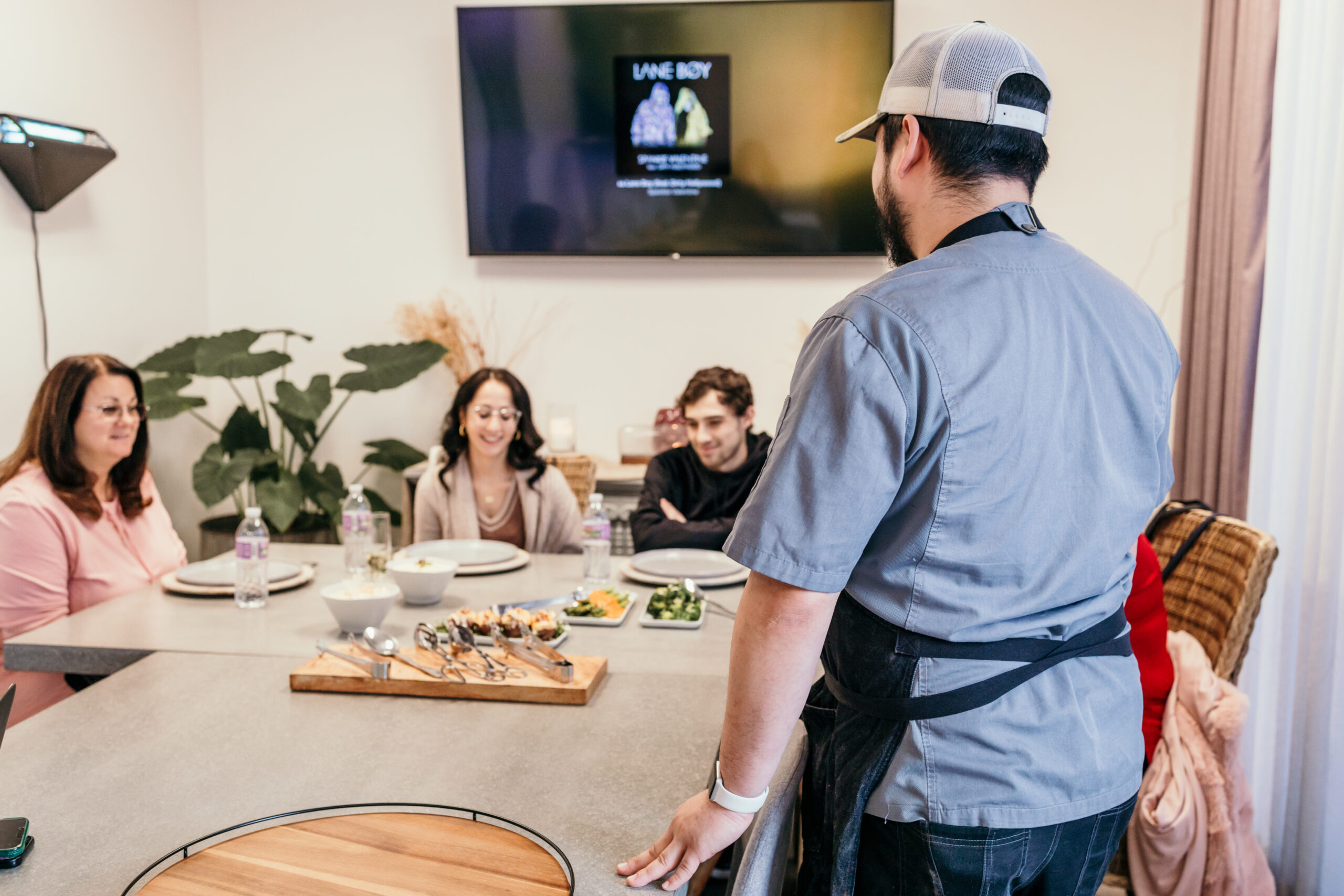 Chef explains tasting dishes to clients.