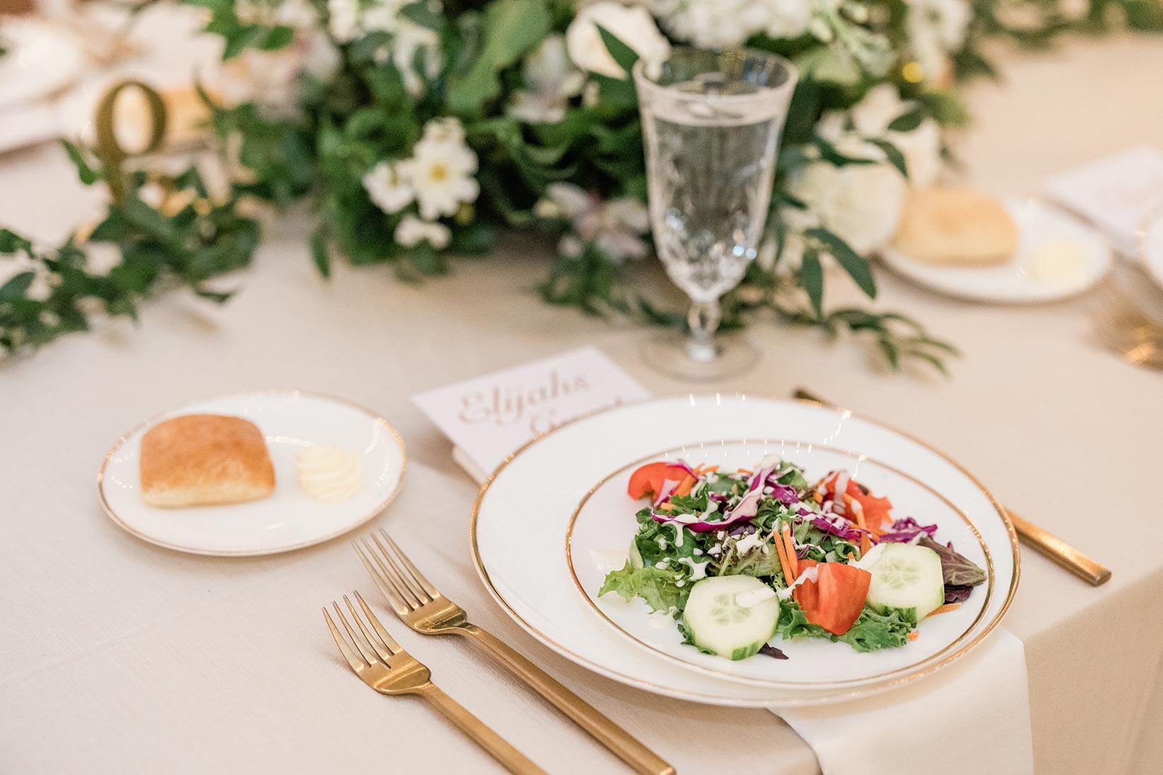 wedding salad and roll with gold utensils