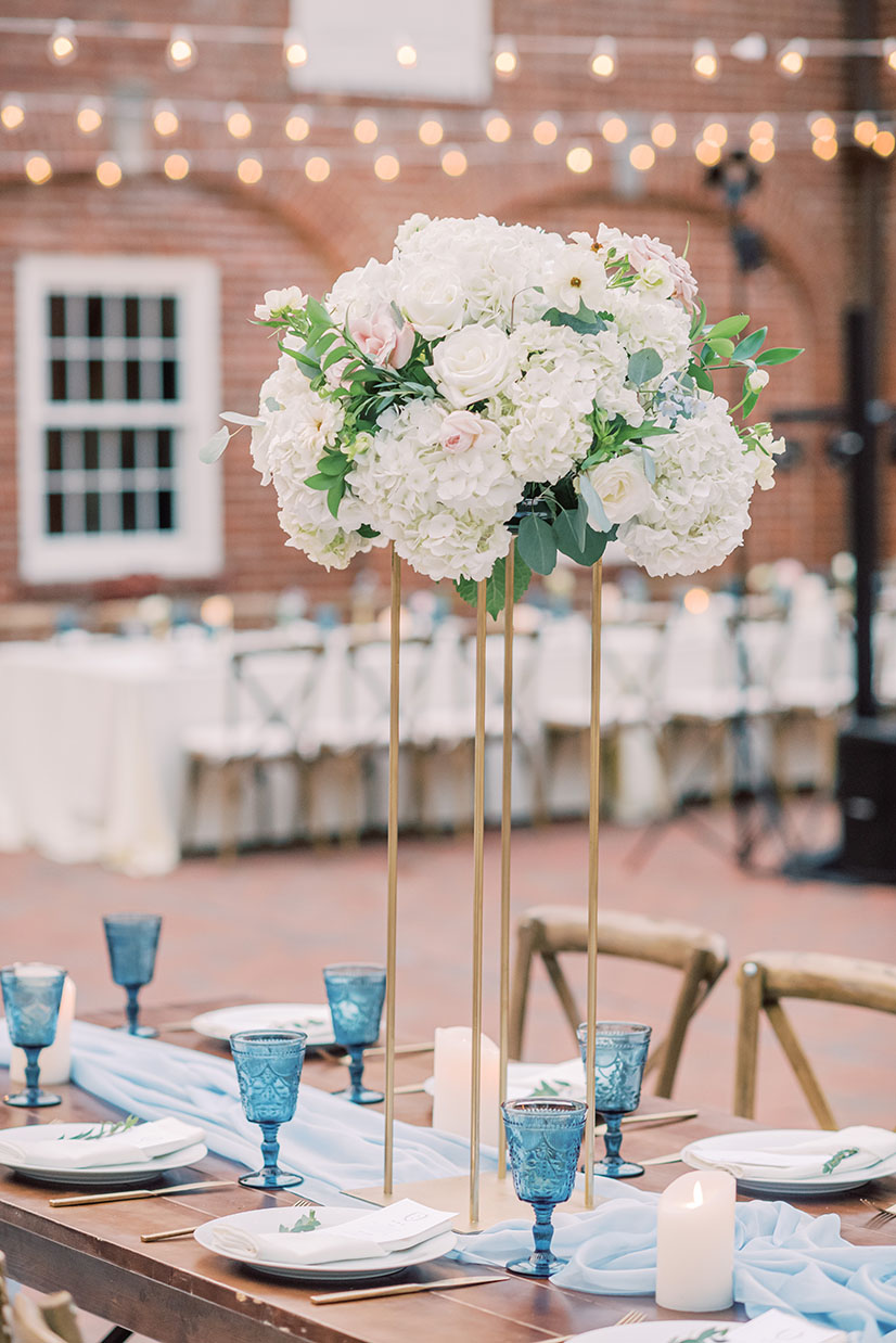 soft blue wedding reception decor with classic floral accents