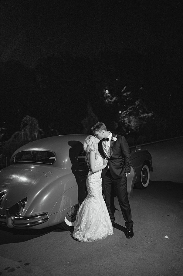 bride and groom with getaway car