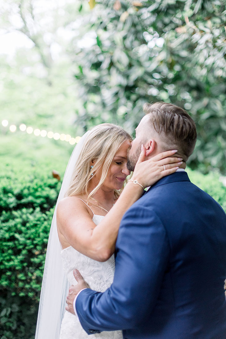 groom kissing brides forehead