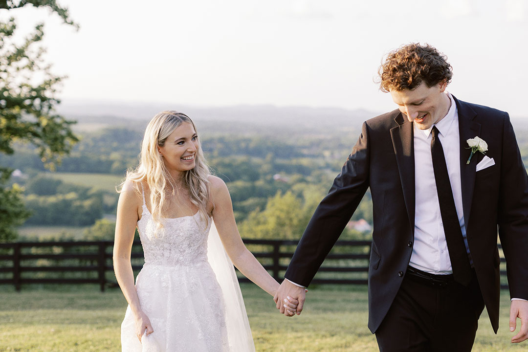 bride and groom holding hands