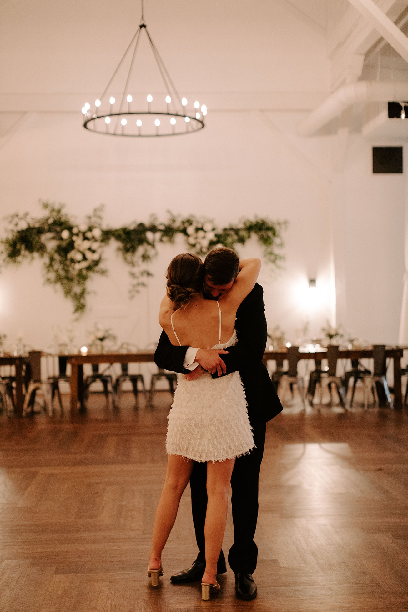 A bride and groom share a private last dance at the end of their wedding reception