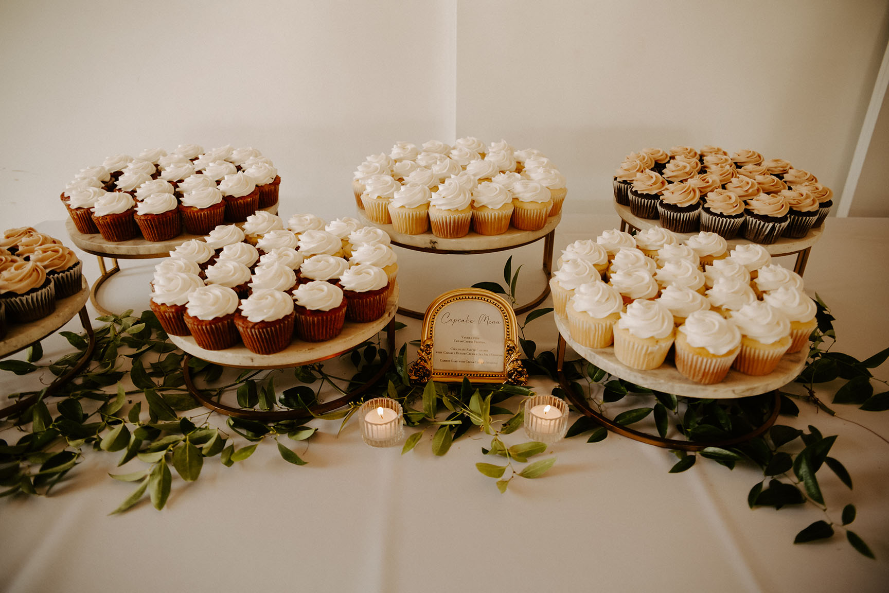 A table of cupcakes for the wedding reception dessert