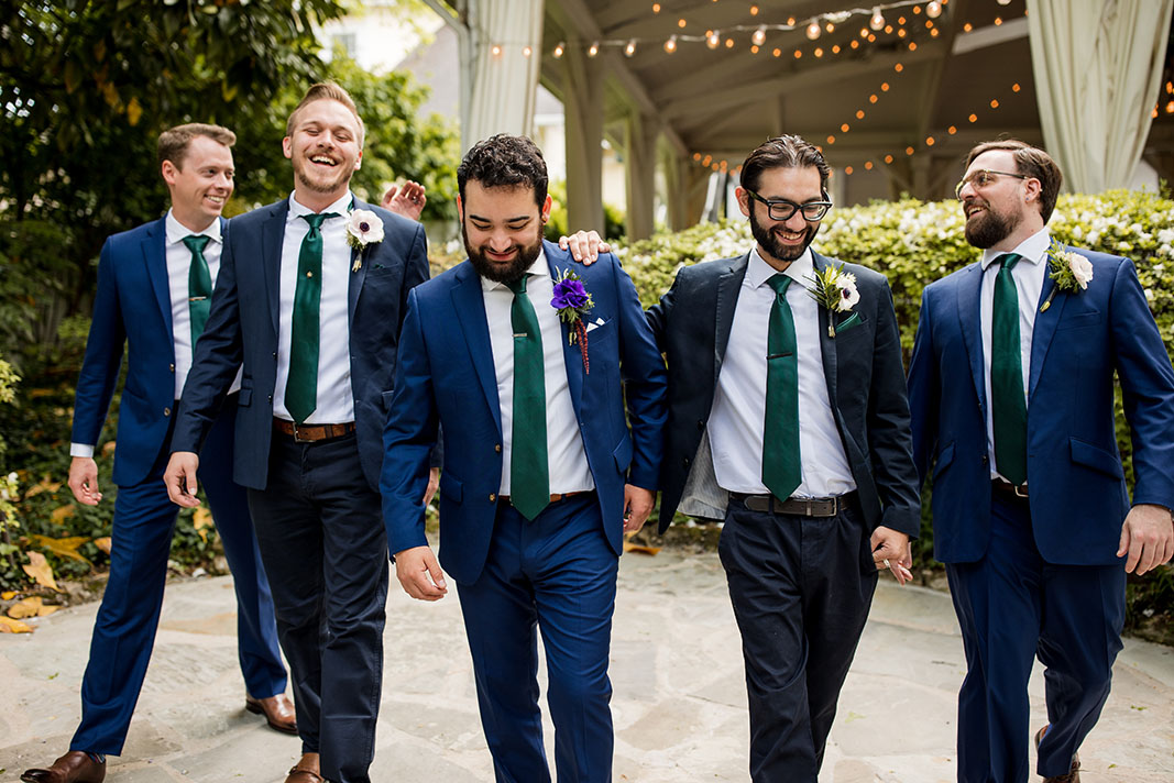 wedding groom and groomsmen in navy tuxedos