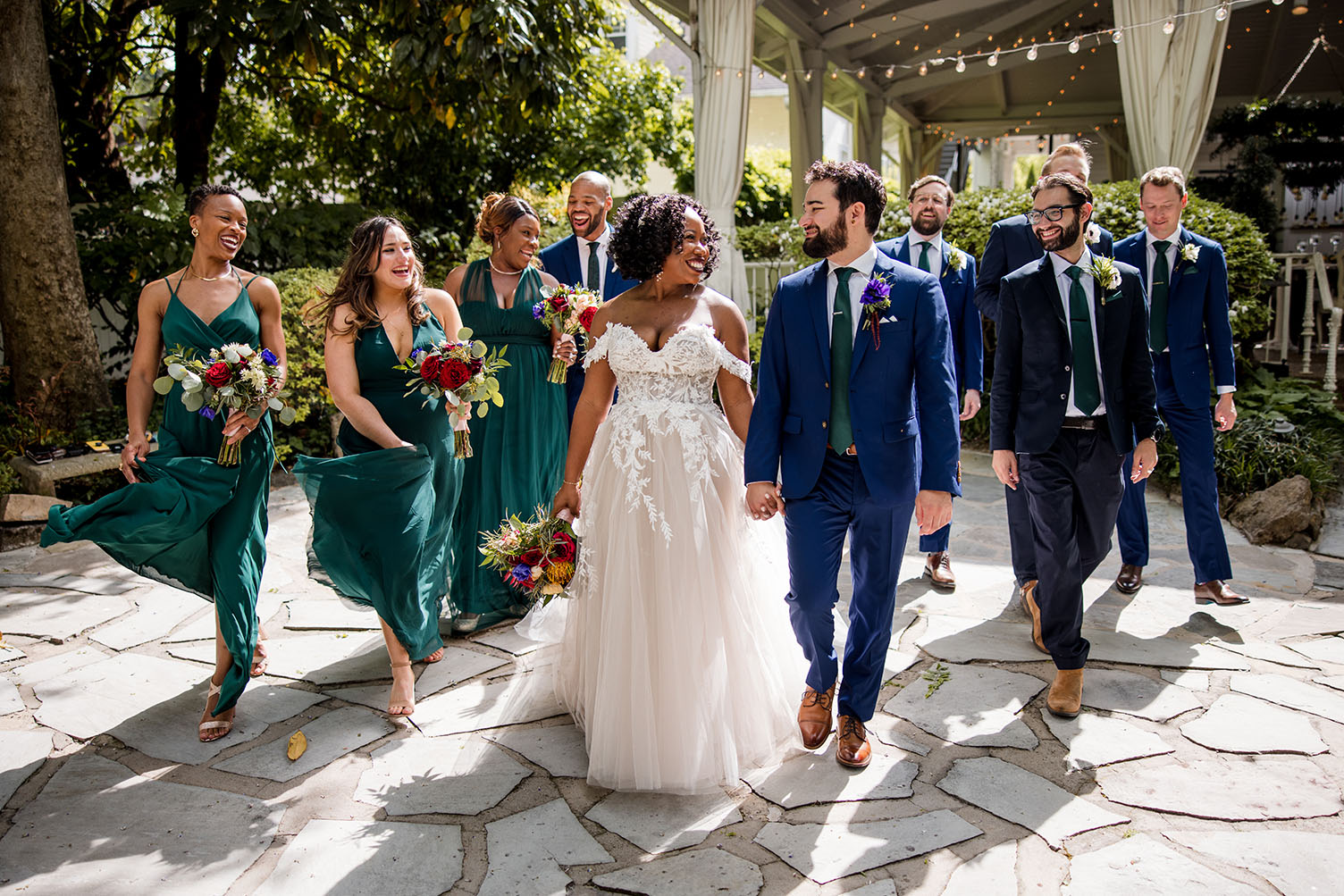 nashville wedding party | bridemaids in emerald green dresses and groomsmen in navy tuxedos