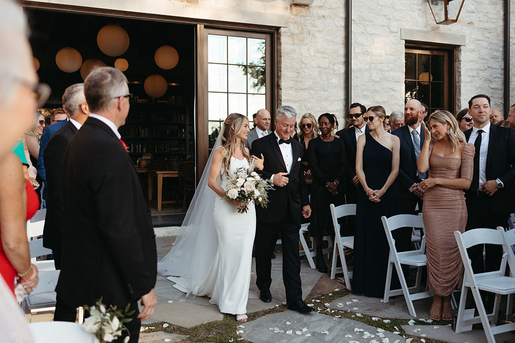 bride and father of the bride walking down aisle