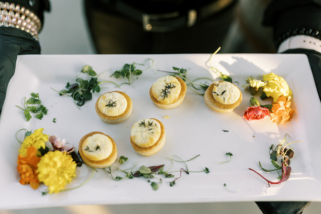 a plate of goat cheese tartlets