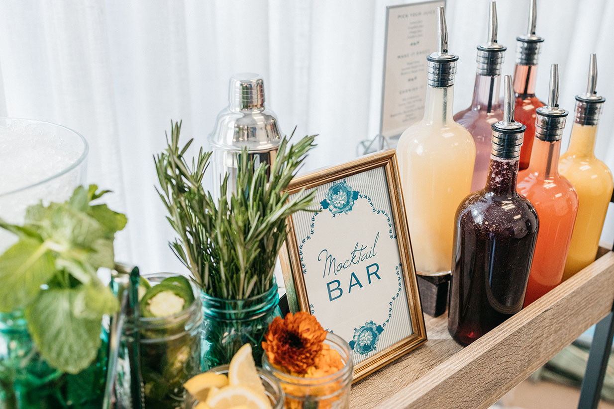 mocktail bar with assorted juices and garnishes