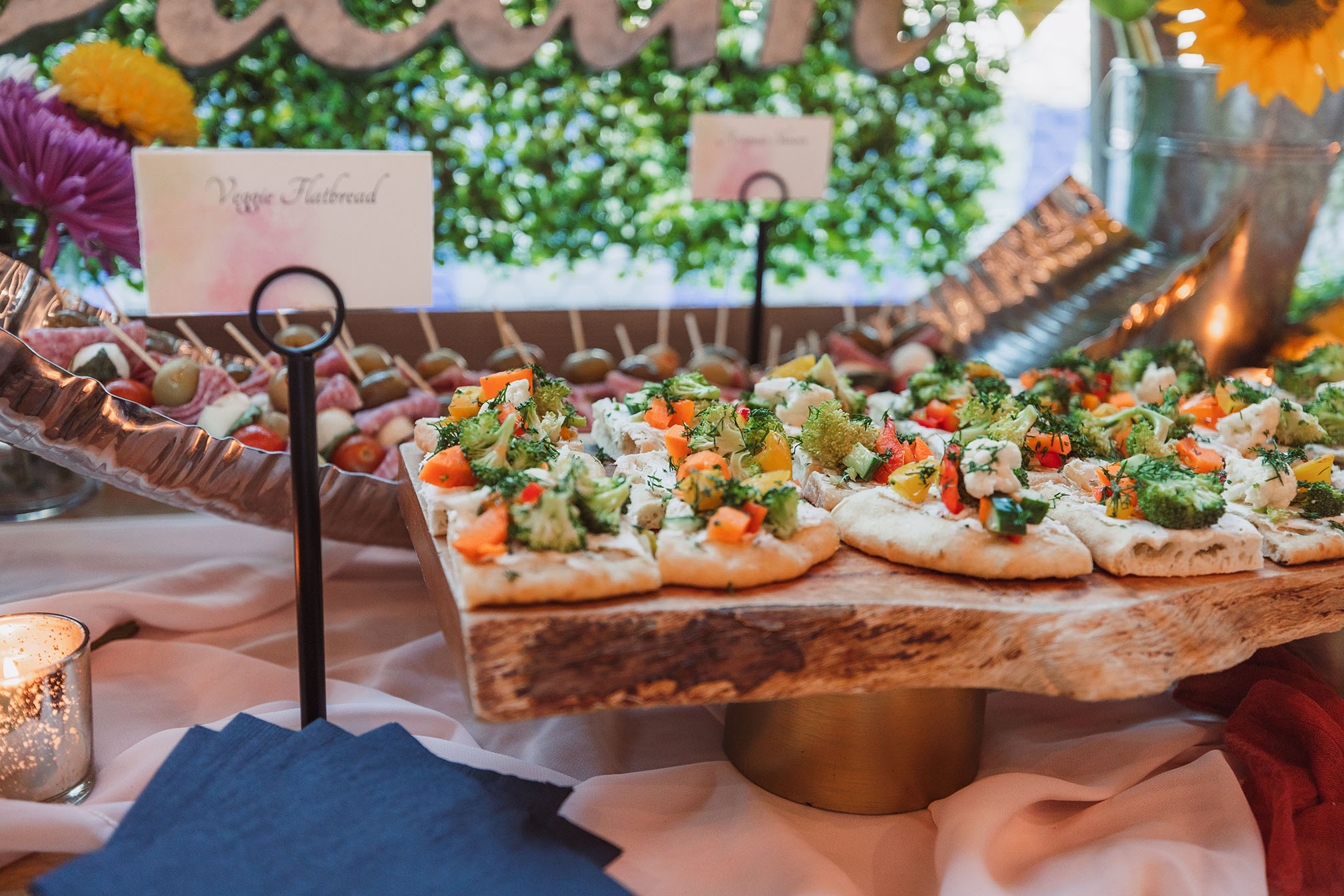 A close-up of vegetable flatbread bites with carrots, broccoli, cauliflower, and more