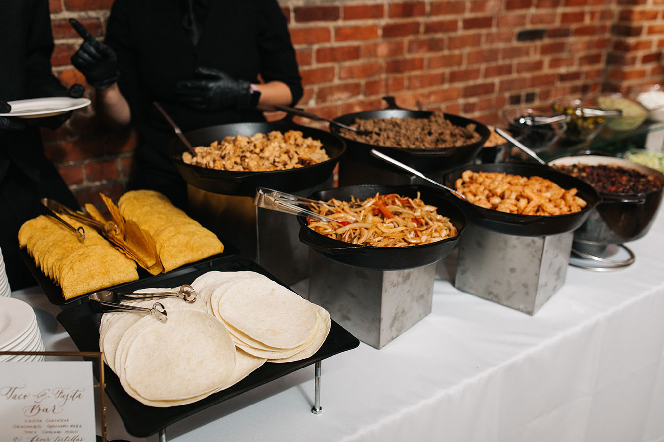 A build your own taco station with hard shells, tortillas, and all the fixins